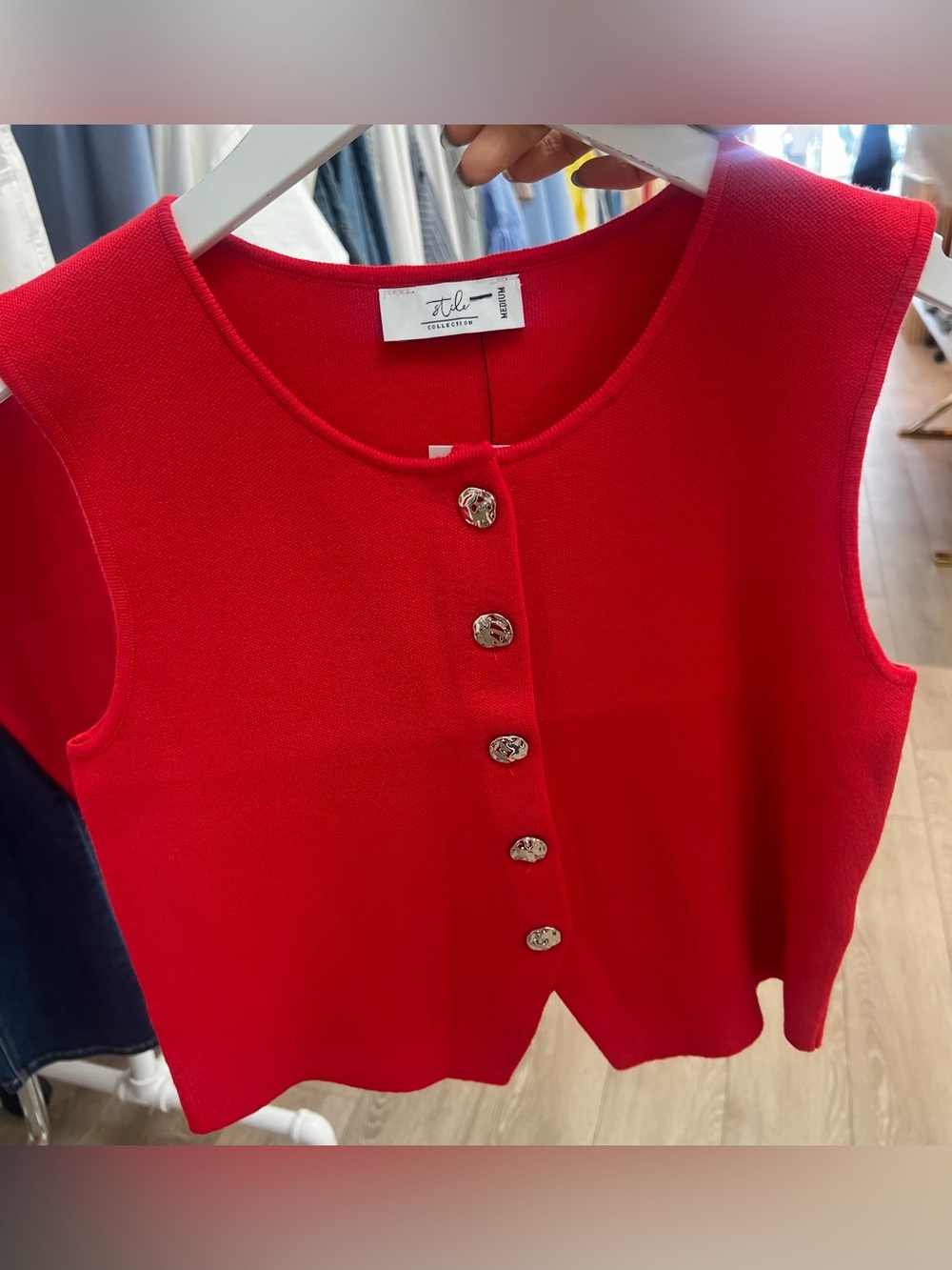 Sleeveless knit vest with silver buttons